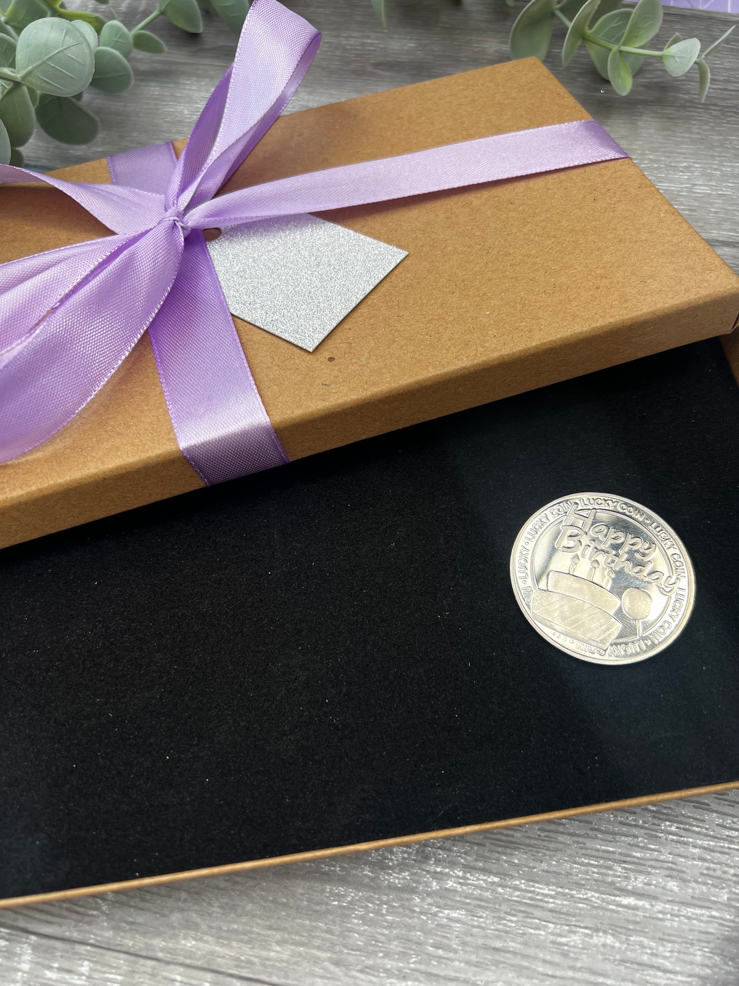 Surprise holiday gifting set including, scratch card, box & birthday coin.